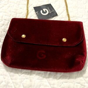Guess Women’s Burgandy evening purse with chain strap and metal front snap.